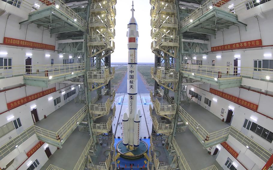 In this photo released by Xinhua News Agency, the Shenzhou-13 manned spaceship onto of a Long March-2F carrier rocket prepares to be transferred to the launching area of Jiuquan Satellite Launch Center in northwestern China, Oct. 7, 2021. China is preparing to send three astronauts to live on its space station for six months — a new milestone for a program that has advanced rapidly in recent years. 