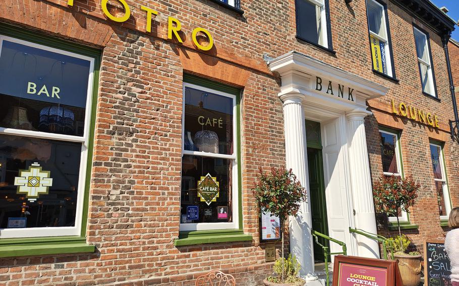 A brick building houses the Potro Lounge in Newmarket, England.
