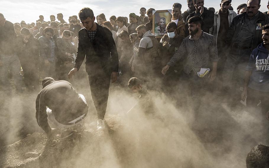 Syrian Kurds attend a funeral of people killed in Turkish airstrikes in the village of Al Malikiyah , northern Syria, on Monday, Nov. 21, 2022. 