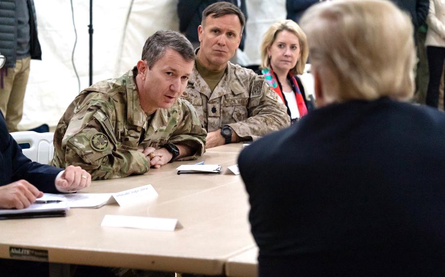 Lt. Gen. Dan Caine talks with President Donald Trump.
