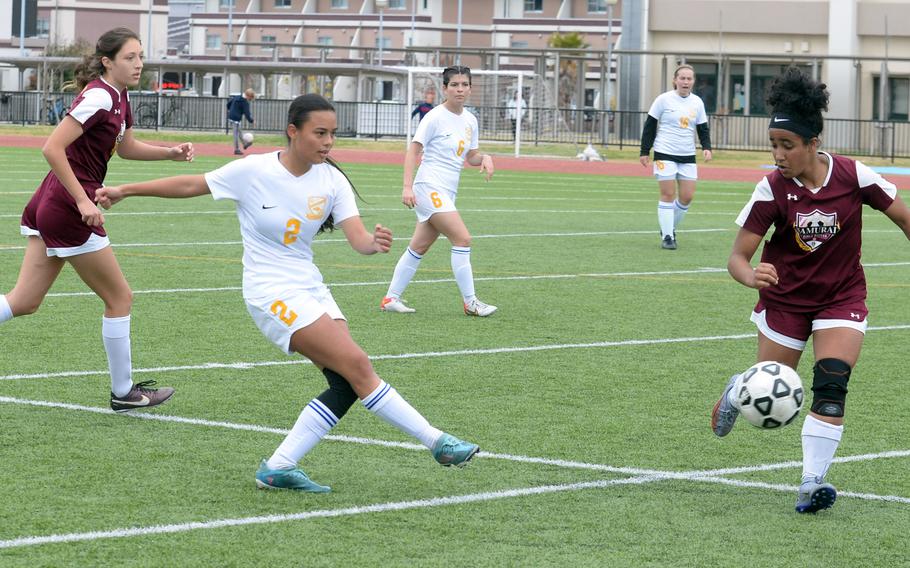 Yokota's Mariah Hilliard boots the ball past Matthew C. Perry's Ivanelis Nieves-Bermudez during Saturday's DODEA-Japan girls soccer match. The teams played to a 2-2 draw.