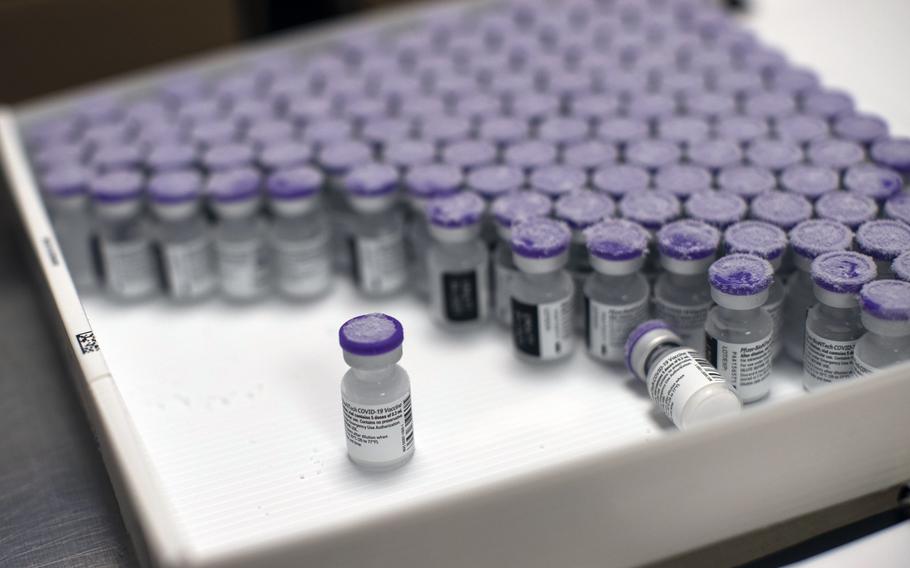 Frozen vials of the Pfizer/BioNTech COVID-19 vaccine are taken out to thaw, at the MontLegia CHC hospital in Liege, Belgium, on Jan. 4, 2021.