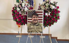 A photo of Tech. Sgt. Clemente Velasco rests in front of two wreaths during a memorial service for him May 19, 2025, at Aviano Air Base, Italy. Velasco died off base in the early hours of April 25. His death is under investigation.