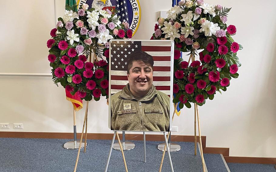 A photo of Velasco rests in front of two wreaths.