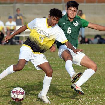 Kadena's Calvin Paguada and Kubasaki's Justin Murray battle for the ball during Wednesday's Okinawa boys soccer match. The Panthers won 3-2.