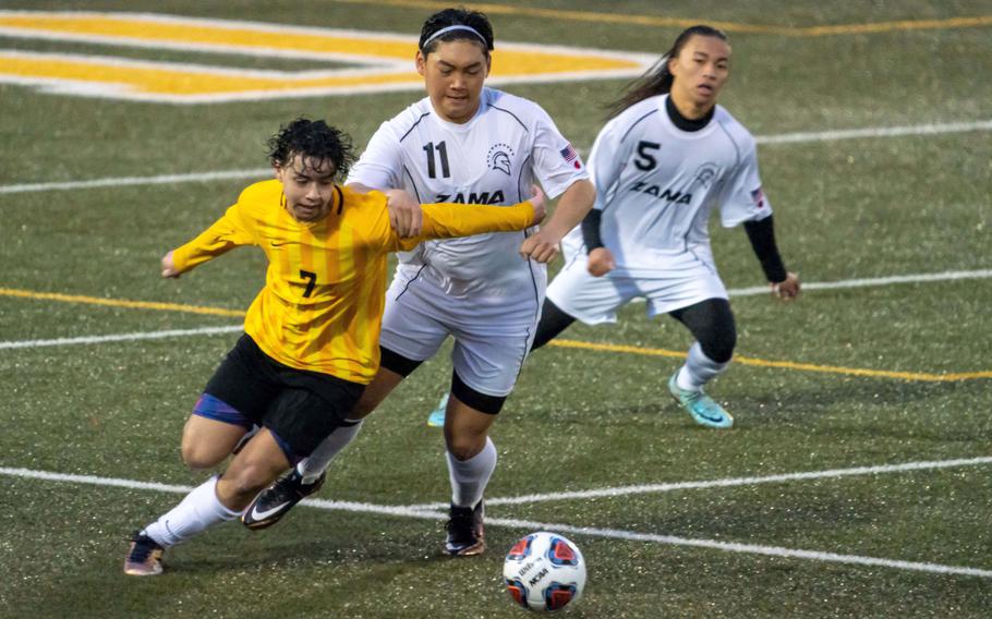 Robert D. Edgren's Axel Nogueras and Zama's Kaisei Muta chase the ball as Trojans teammate Jayrielle Sunglao watches during Friday's Japan boys soccer friendly match. The Trojans won 8-0. 