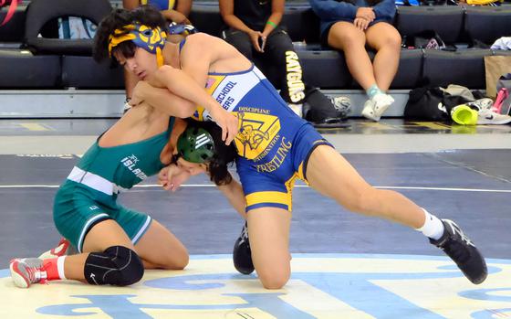 Guam High 120-pounder Jose Camacho gains the edge on John F. Kennedy's Rhys Gomez during Saturday's Guam wrestling quad meet. Camacho pinned Gomez in 1 minute, 30 seconds and the Panthers won the meet 54-14.