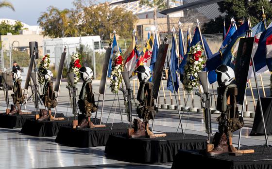 Rifles, flight gear, boots and a wreath with photos of each of five Marines of Heavy Marine Helicopter Squadron 361 memorialized at MCAS Miramar on Feb. 16, 2024.