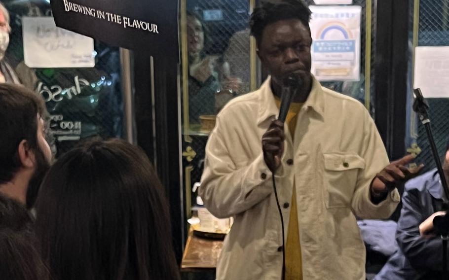 Comedian Evans Musoka, 34, a native of Nairobi, Kenya, performs at the An Solas Irish Pub in Shibuya, Tokyo, April 2, 2022. 