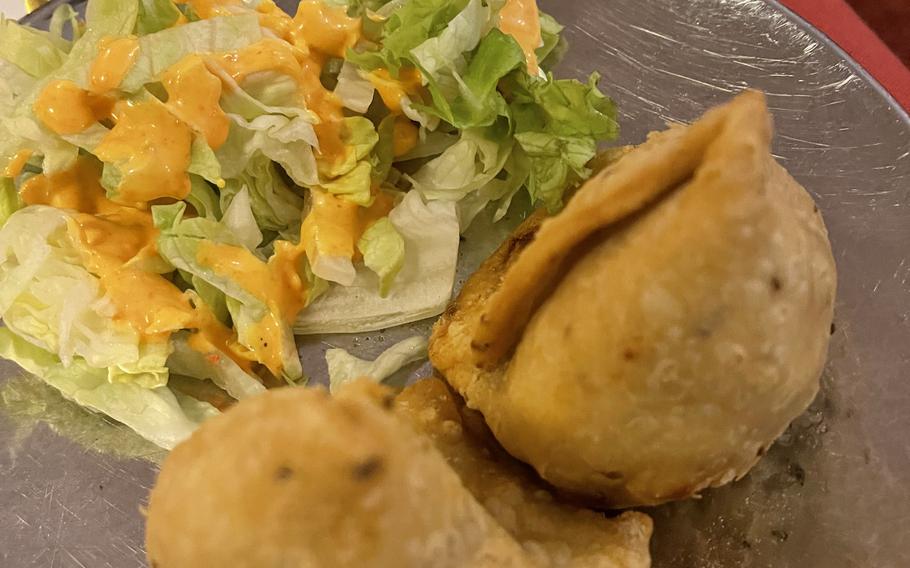 Ganesha offers samosas that include assorted vegetables fried in chickpea dough in Weiden, Germany, December 21, 2021. Ganesha's range includes naan, tandoori, chicken, lamb, fish and vegetarian offerings.
