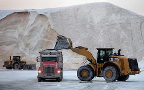 A front-end loader dumps road salt into a truck Friday, Jan. 28, 2022, in Chelsea, Mass. Residents and officials in the Northeast and mid-Atlantic regions of the U.S. are bracing for a powerful winter storm expected to produce blizzard conditions Friday and Saturday. 
