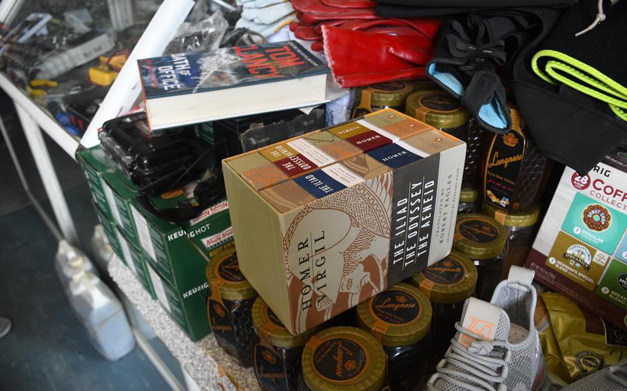 A shopkeeper outside Bagram Airfield, Afghanistan, sells books thrown out by departing U.S. and NATO troops June 5, 2021. Items too heavy or expensive to ship back home are often discarded. 