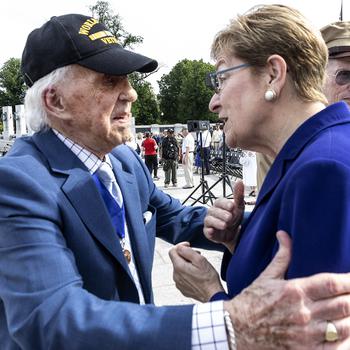 World War II Merchant Marine veteran Dave Yoho hugs Rep. Marcy Kaptur, D-Ohio, before the 20th anniversary celebration of the National World War II Memorial in Washington, D.C., May 25, 2024.