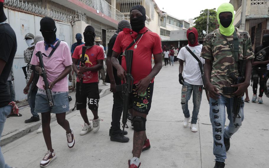 Armed members of “G9 and Family” march in a protest against Haitian Prime Minister Ariel Henry in Port-au-Prince, Haiti, Sept. 19, 2023.