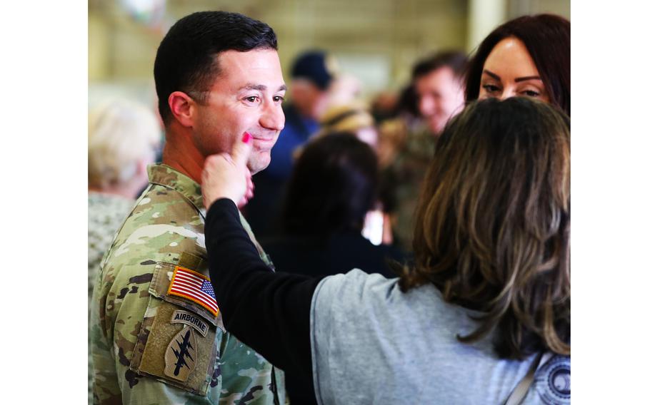 A woman touches the cheek of a soldier