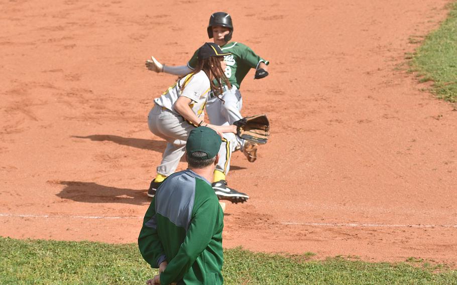 Naples’ Matthew Butler slides into third ahead of the throw to Vicenza’s Jace Herron as Naples coach Jim Davis watches on Saturday, April 20, 2024.