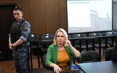 FILE - Marina Ovsyannikova, a former Russian state TV journalist who quit after making an on-air protest of Russia's military operation in Ukraine, sits in a court room prior to a hearing in Moscow, Russia, Thursday, July 28, 2022. Russian authorities on Wednesday raided the home of a former state TV journalist who quit after making an on-air protest against Moscow's special military operation in Ukraine. The case against Marina Ovsyannikova was launched under a law that penalizes statements against the military. (AP Photo/Alexander Zemlianichenko, File)