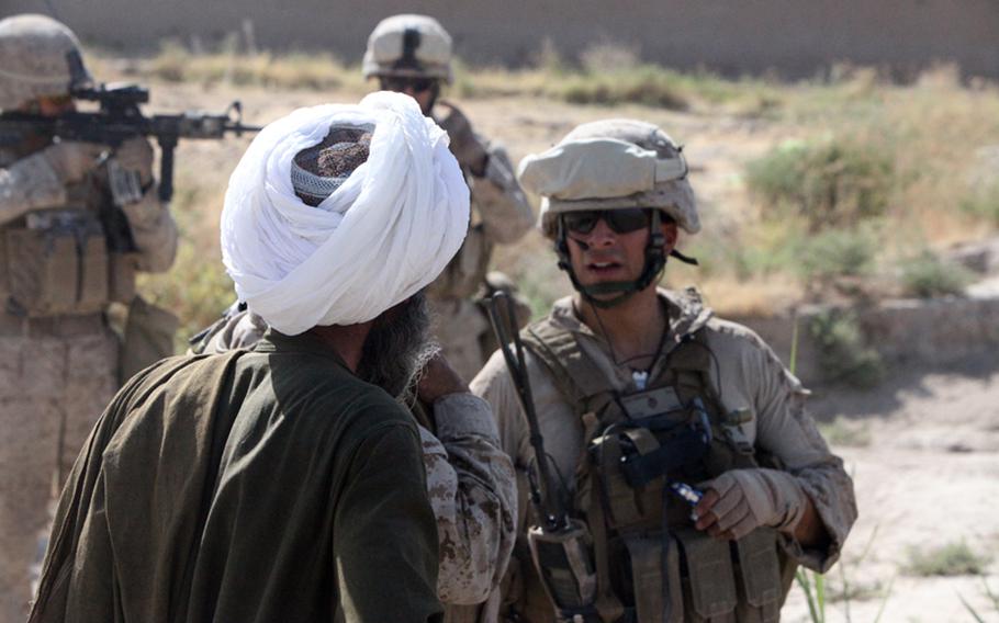 Maj. Anthony Aragon, a civil affairs team leader with 1st Battalion, 2nd Marine Regiment, Regimental Combat Team 2, talks to an Afghan contractor about a canal project during a patrol in 2010. While most work contracts in support of Afghanistan have been settled, the military unit closing out these contracts says the process could take years to fully close, due to the possibility of future claims and litigation by contractors.