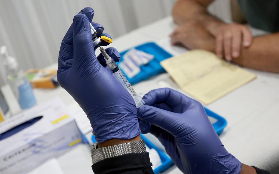 A health care worker prepares to administer a monkeypox vaccine at the Pride Center on July 12, 2022, in Wilton Manors, Florida. 