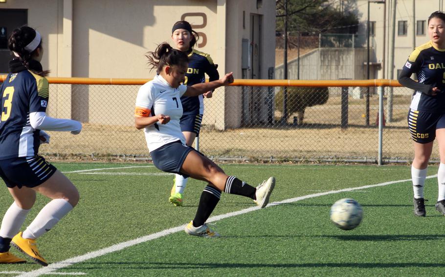 Osan’s Jazmine Butalina boots the ball upfield against Cheongna Dalton defenders during Friday’s Korea girls soccer match. Lunn scored a hat trick and the Cougars won 4-0.