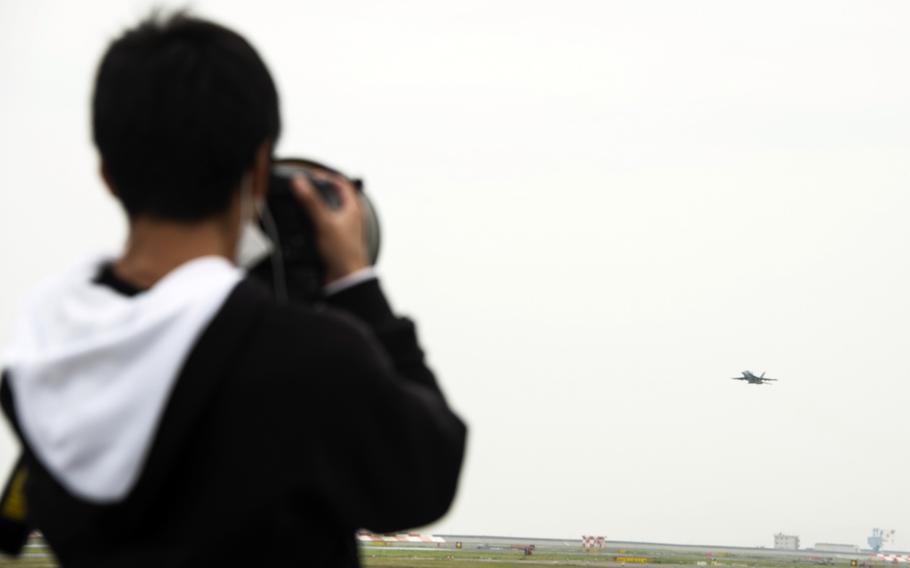 Masafumi Mizuoka, a college student from Osaka, photographs aircraft taking off from Marine Corps Air Station Iwakuni, Japan, April 19, 2023.