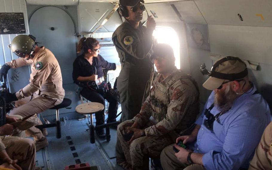 Zainab Olivo holds a camera while on a reporting assignment in Iraq with Stars and Stripes journalist Chad Garland, far right, in 2017.