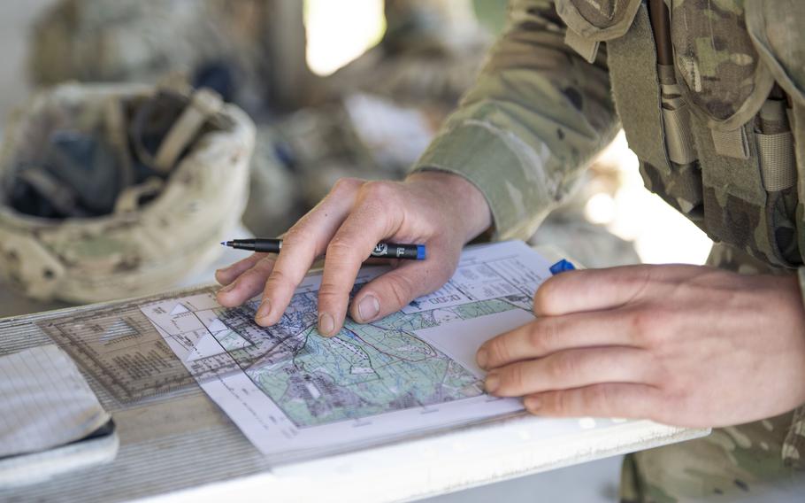 A closeup of hands with a pen on a map.