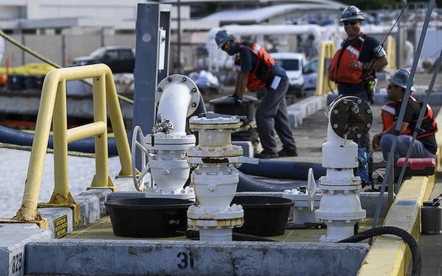 Naval Supply Systems Command Fleet Logistics Center Pearl Harbor fuel distribution system workers prepare to begin an unpacking operation onboard Joint Base Pearl Harbor-Hickam, Hawaii, on Oct. 27, 2022.