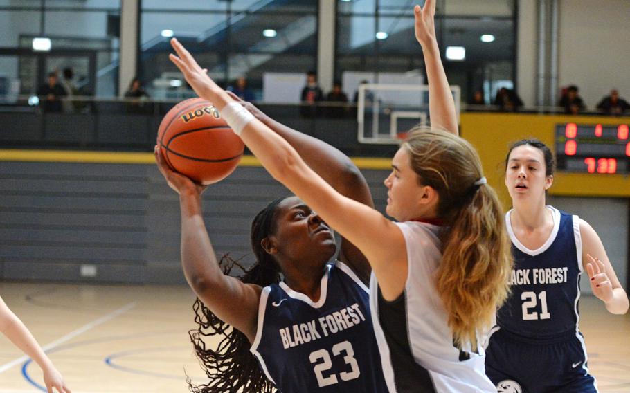 Black Forest Academy’s Abiele Kenmogne tries to get a shot off against American Overseas School of Romes’s Natalia DiMatteo in a Division II semifinal at the DODEA-Europe basketball championships in Ramstein, Germany, Feb. 17, 2023. AOSR beat BFA 34-31 to advance to the championship game against Naples.