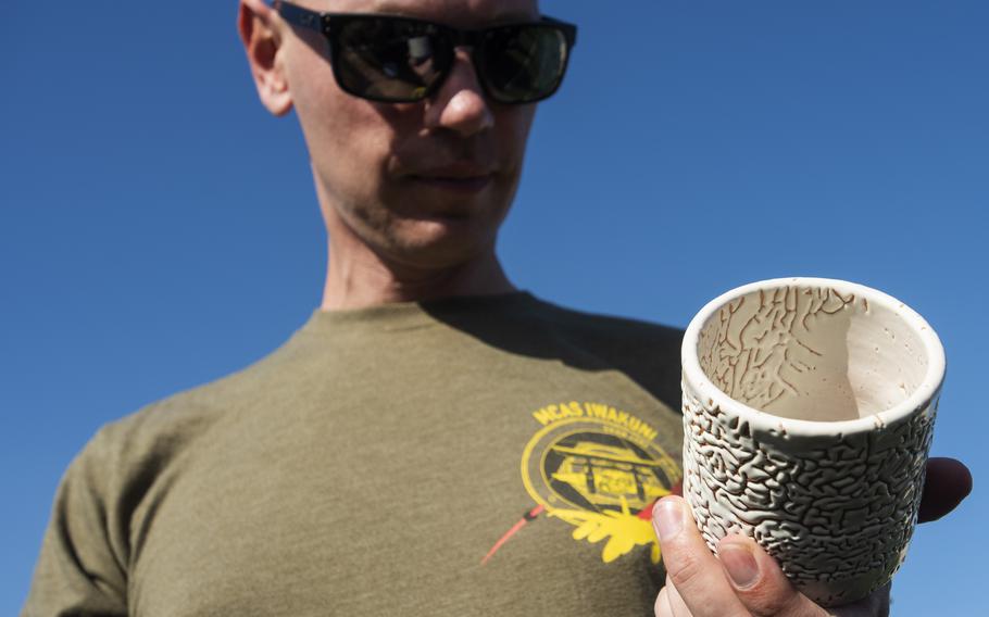 Marine Gunnery Sgt. Rusavskiy Vitaliy, 37, of Spokane, Wash., examines the cup awarded to first-place finishers during Sports Day at Marine Corps Air Station Iwakuni, Japan, on Oct. 28, 2022.