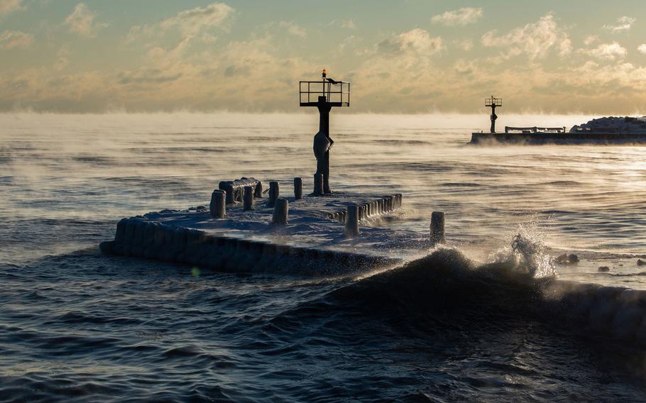 Lake Michigan waves splash against a breakwater at sunrise at 31st Street Beach in Chicago on Jan. 29, 2019. 