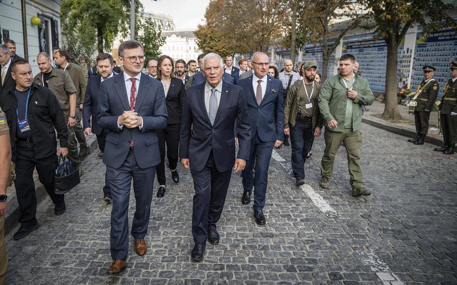 Ukrainian Foreign Minister Dmytro Kuleba, center left, and European Union Foreign Policy Chief Josep Borrell visit the Memory Wall of Fallen Defenders of Ukraine in Kyiv, on Oct. 2, 2023. 
