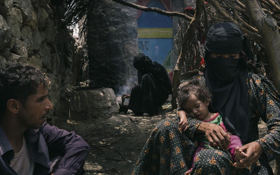 Bushra Ali Sagheer Surban holds her daughter Reena outside their home with her husband, Mohammed Fulait Ahmed. 