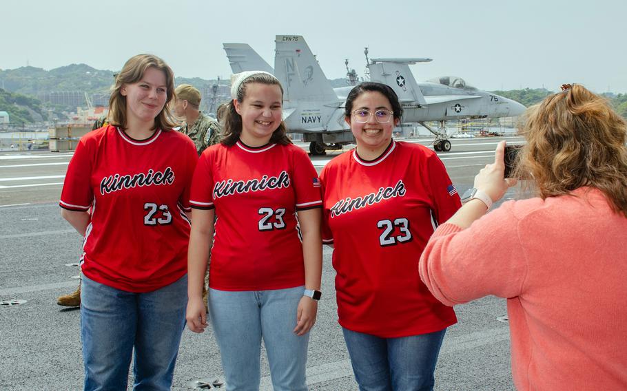 Seniors from Nile C. Kinnick High School pose aboard the aircraft carrier USS Ronald Reagan at Yokosuka Naval Base, Japan, April 18, 2023.