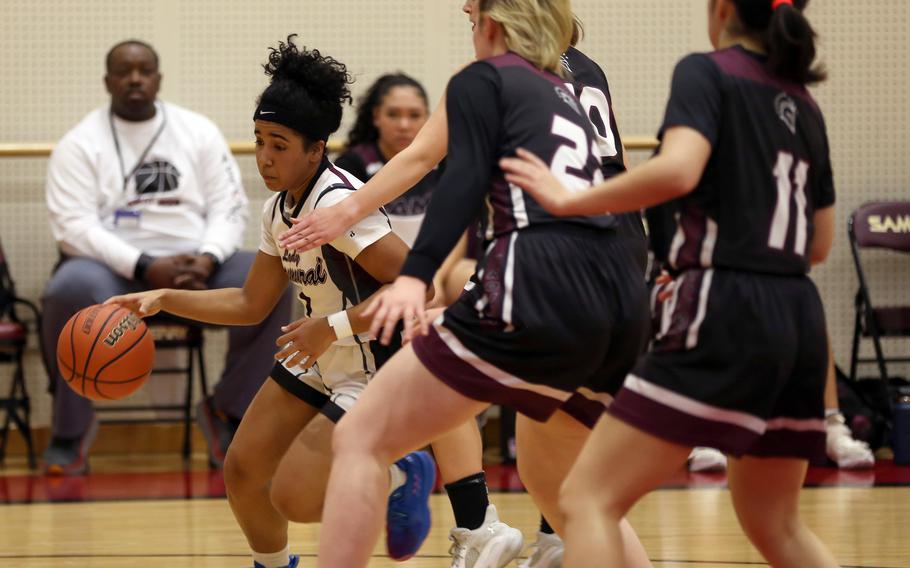 Matthew C. Perry's Ivanelis Nieves drives past Zama's defense during Friday's DODEA-Japan girls basketball game. The Trojans won 39-31.