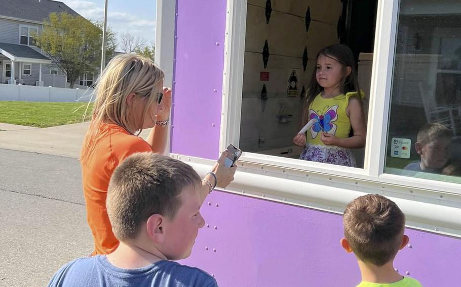 Charlie Cumbie, 6, helps out with her family's ice cream truck, which makes rounds in and around Whiteman Air Force Base, Mo. 