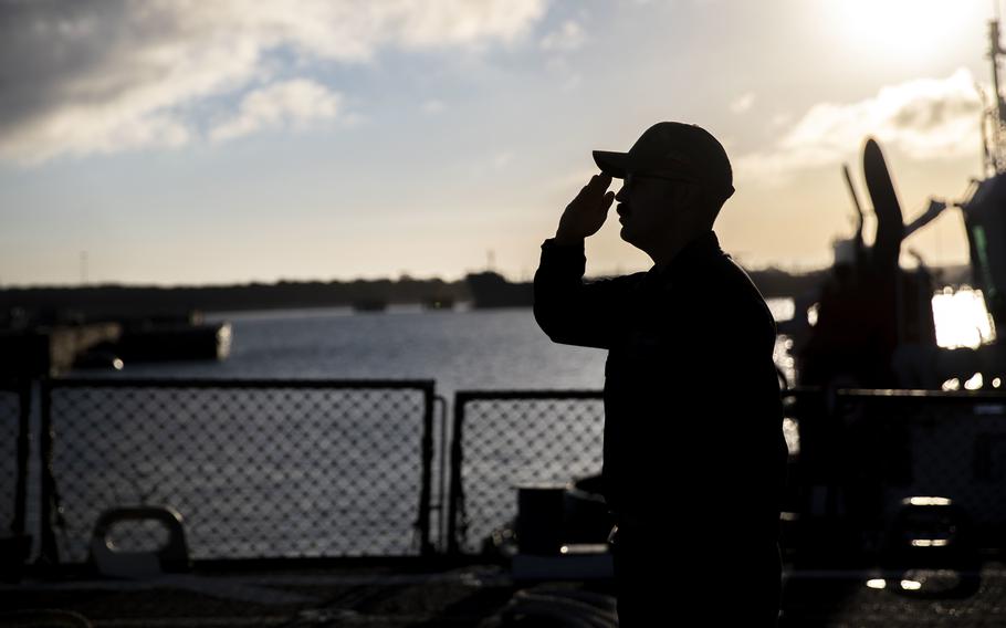 Chief Fire Controlman Derek P. Cox salutes the ensign during morning colors aboard the guided-missile destroyer USS Arleigh Burke onboard Naval Station Rota, Spain, June 1, 2022. 