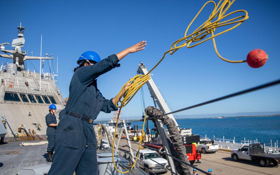 Sailors work aboard the USS Milwaukee as it arrives at Naval Station Guantánamo Bay on Dec. 20, 2021.