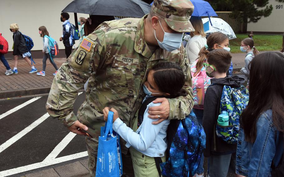 Army Chief Warrant Officer 4 Matthew Keechi hugs his daughter Natalie on Monday, Aug. 23, 2021, before dropping her off at Ramstein Intermediate School for the first day of the new school year.