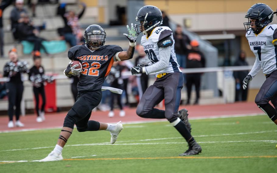 Spangdahlem's Deon Montgomery tries to stiff-arm Ansbach's Josiah Jackson before he is pushed out of bounds during the 2019 Division III Football Championship game in Kaiserslautern, Germany. The 2021 season will get underway this weekend after last year's games were cancelled due to the coronavirus pandemic.