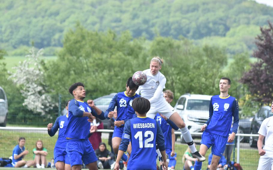 Wiesbaden's Michael Santos heads the ball before Ramstein's Kelan Vaughn can get to it in the Warriors' 2-0 victory over the Royals on Wednesday, May 17, 2023, in the semifinals of the DODEA-Europe Division I boys championships.