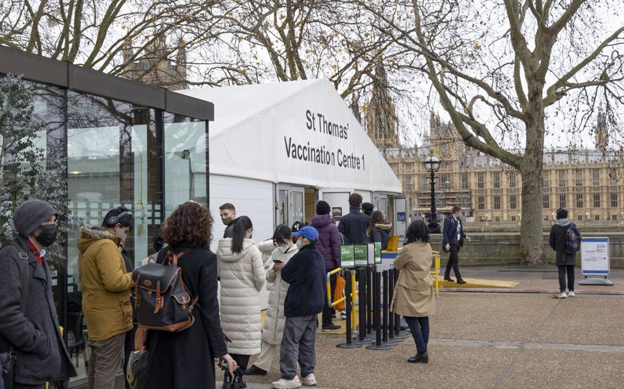 Members of the public line up for Covid-19 booster vaccinations at St. Thomas hospital, near the Houses of Parliament in London on Dec. 16, 2021. 