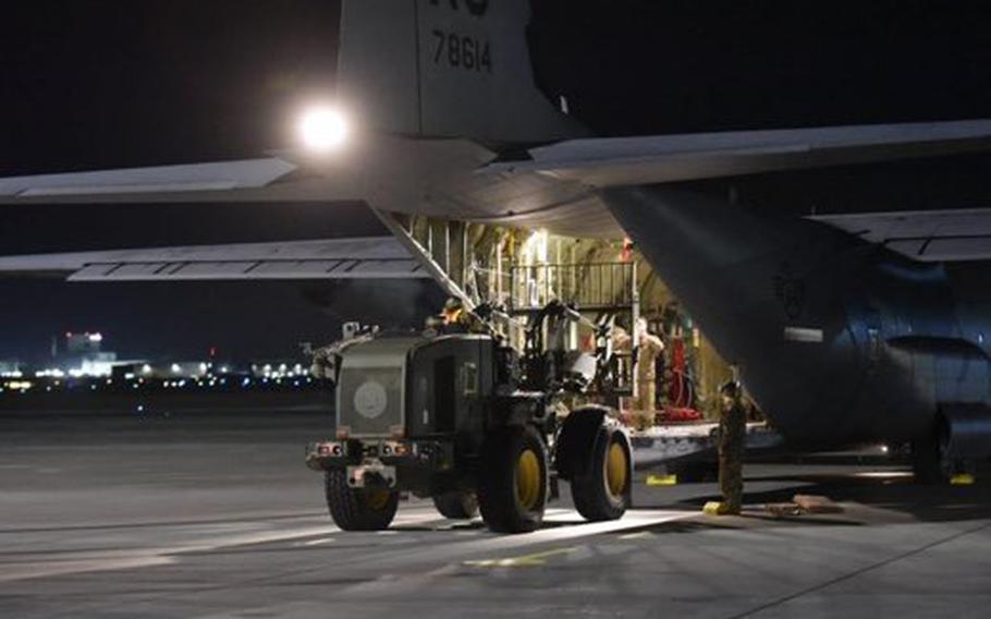 Airmen unload equipment from a U.S. Air Force C-130 cargo plane in Poland, in preparation for the arriving 82nd Airborne Division troops. About 1,700 Fort Bragg-based troops will be deployed to Poland, U.S. officials said.