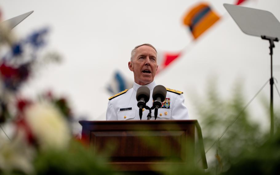 Adm. Kevin Lunday stands at a podium and speaks. 