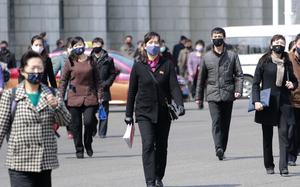 Pedestrians wear face masks to help prevent the spread of the new coronavirus in Pyongyang, North Korea, on April 1, 2020. North Korea is putting surveillance cameras in schools and workplaces, and collecting fingerprints, photographs and other biometric information from its citizens in a technology-driven push to monitor its population even more closely, a report said Tuesday, April 16, 2024.