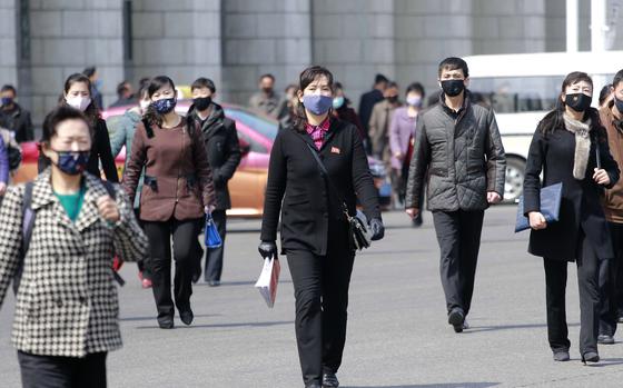 Pedestrians wear face masks to help prevent the spread of the new coronavirus in Pyongyang, North Korea, on April 1, 2020. North Korea is putting surveillance cameras in schools and workplaces, and collecting fingerprints, photographs and other biometric information from its citizens in a technology-driven push to monitor its population even more closely, a report said Tuesday, April 16, 2024.