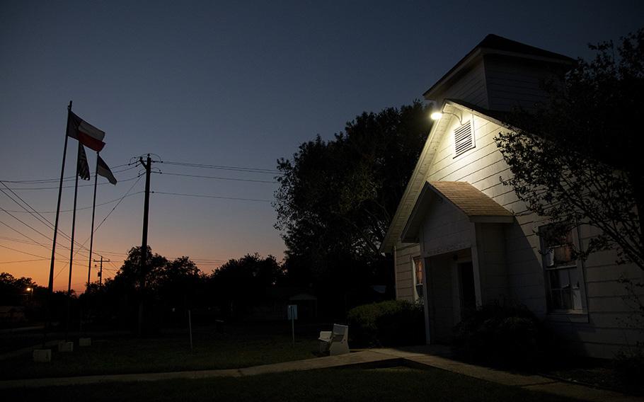 Dusk falls over the original building of the First Baptist Church of Sutherland Springs, which was turned into a memorial after the 2017 mass shooting. 