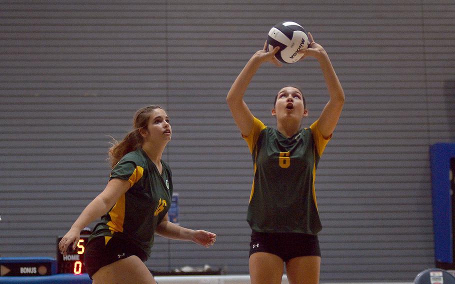 SHAPE's Juliette Laforest sets the ball during SHAPE's match against Lakenheath during pool-play action of the DODEA European volleyball championships on Oct. 26, 2023, at Southside Fitness Center on Ramstein Air Base, Germany.
