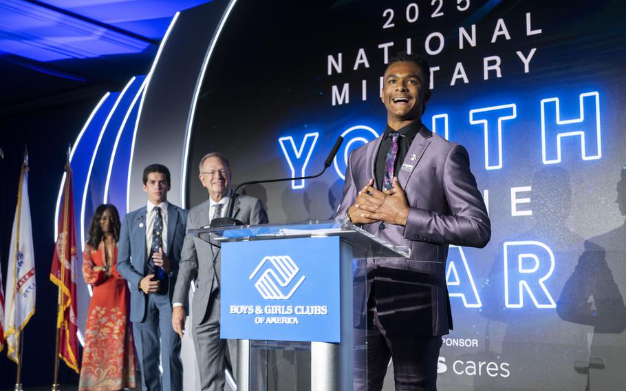 A teenager speaks at a podium.