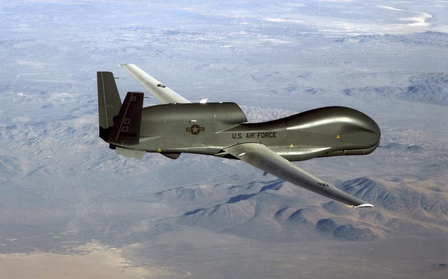 An RQ-4 Global Hawk soars through the sky to record intelligence, surveillence and reconnaissance data. 